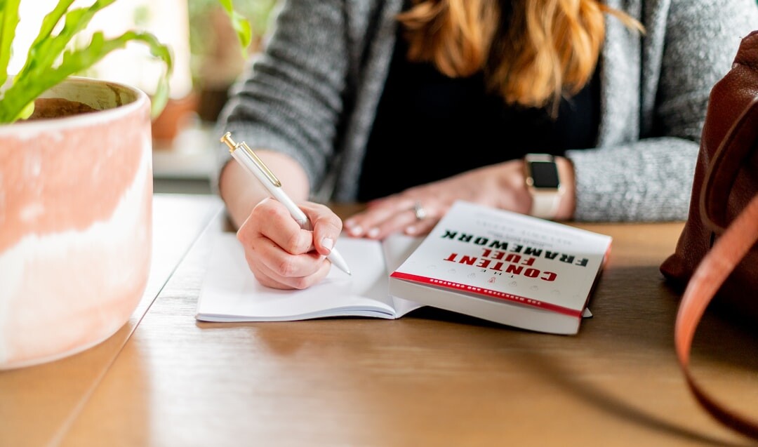 writer at desk with notebook